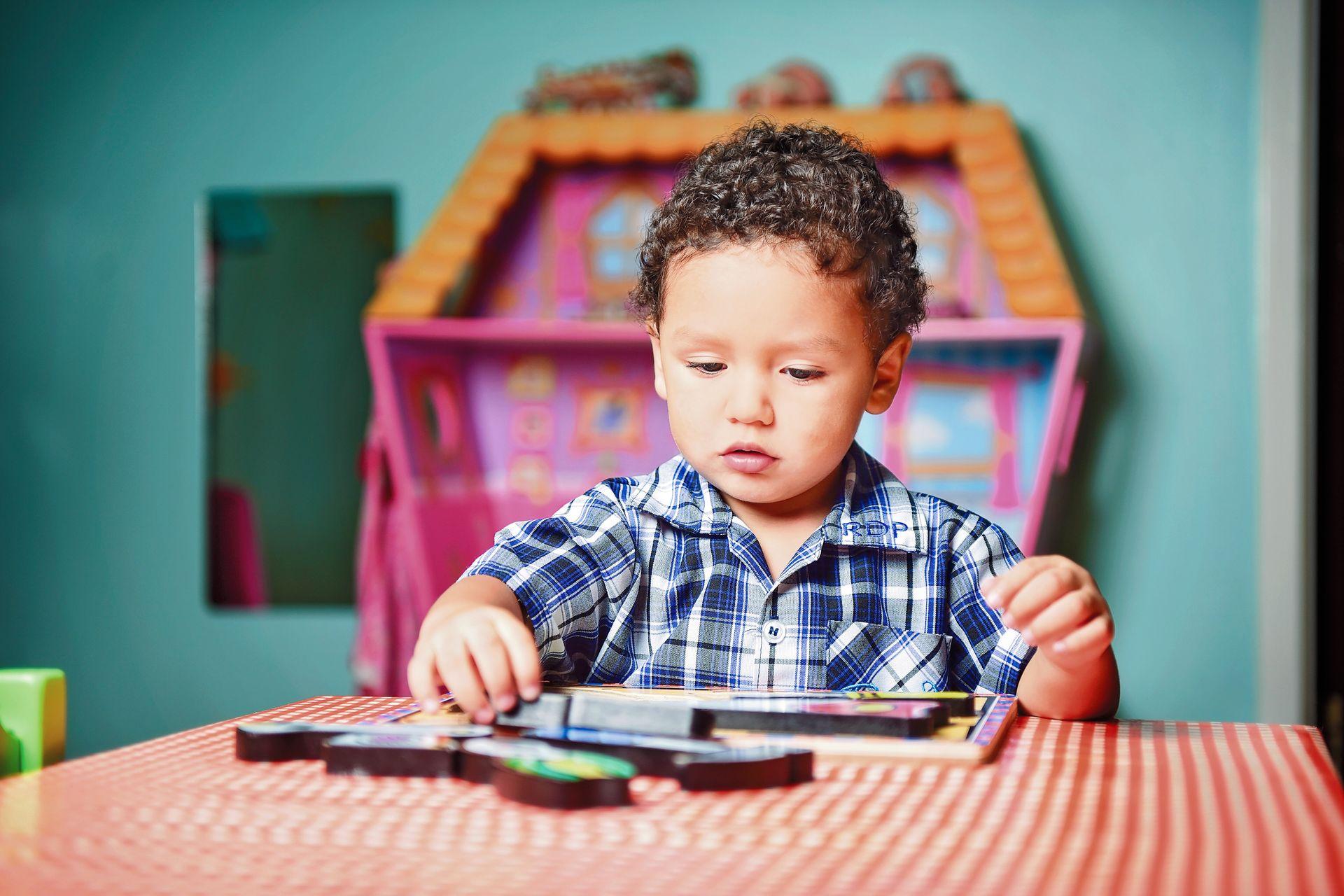 Child playing with puzzle.